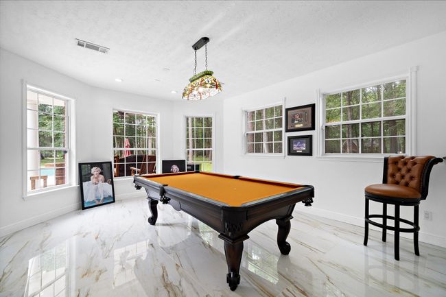 Game area with large windows and a bright interior. | Image 26