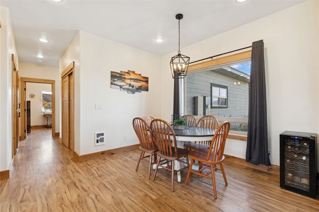 Dining space featuring recessed lighting, beverage cooler, light wood finished floors, baseboards, and a notable chandelier | Image 16