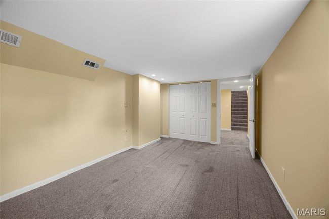 Finished basement with carpet, stairway, and recessed lighting | Image 29
