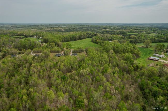 Bird's eye view featuring a wooded view | Image 24