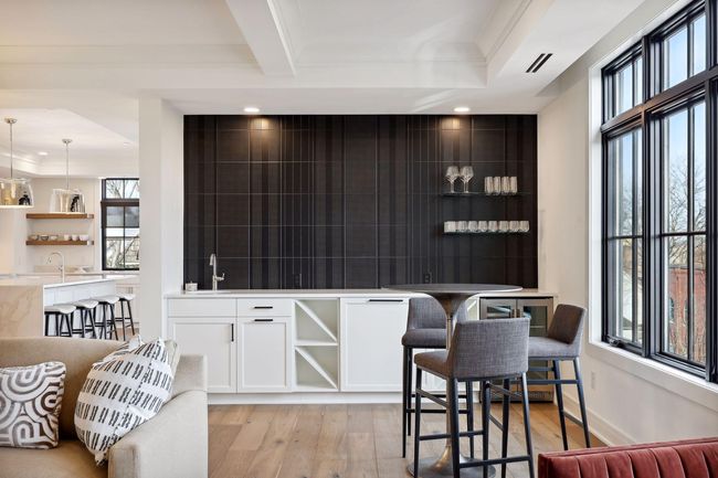 The bar area features floating shelves, sink, dual zone beverage center and a great backdrop for some impressive artwork | Image 7