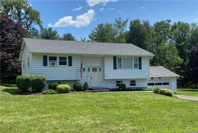 Split foyer home featuring a garage and a front lawn | Image 2