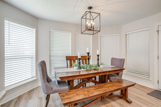 Dining area featuring a chandelier and light wood-style floors | Image 13
