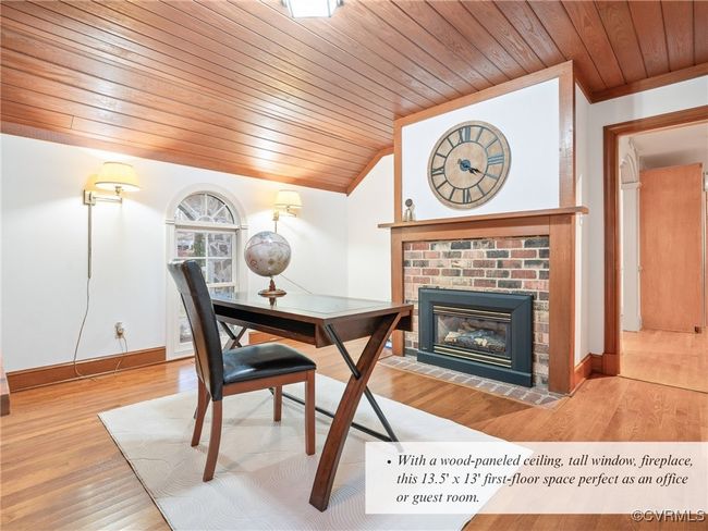 With a wood-paneled ceiling, tall window, fireplace, this 13.5' x 13' first-floor space perfect as an office or guest room. | Image 25