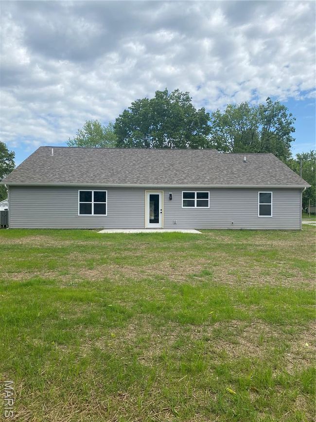 Ranch-style home with driveway, a garage, and roof with shingles | Image 31