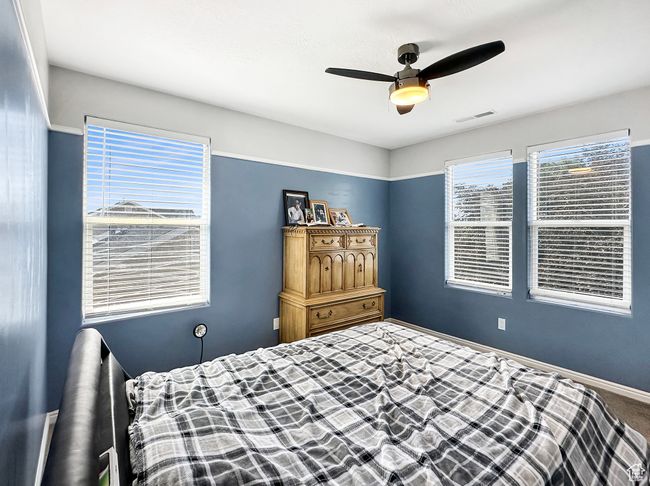 Carpeted bedroom with ceiling fan | Image 9