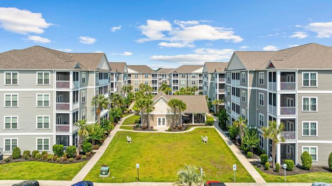 View of building exterior with uncovered parking and a residential view | Image 32