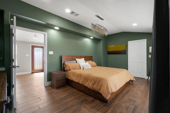 The bold color palette in the primary bedroom infuses the space with energy, creating a dynamic atmosphere that feels both vibrant and inviting | Image 14