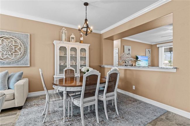 Dining room with a chandelier, ornamental molding, and baseboards | Image 15