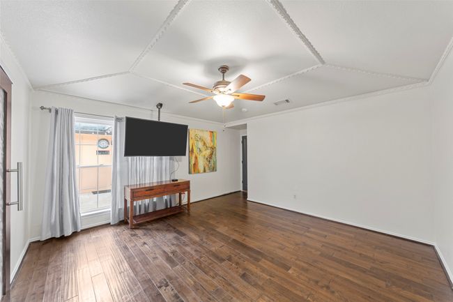 Spare room featuring dark wood finished floors, visible vents, ceiling fan, and baseboards | Image 15
