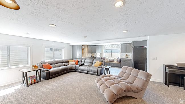 Living area featuring carpet, baseboards, and a wealth of natural light | Image 27