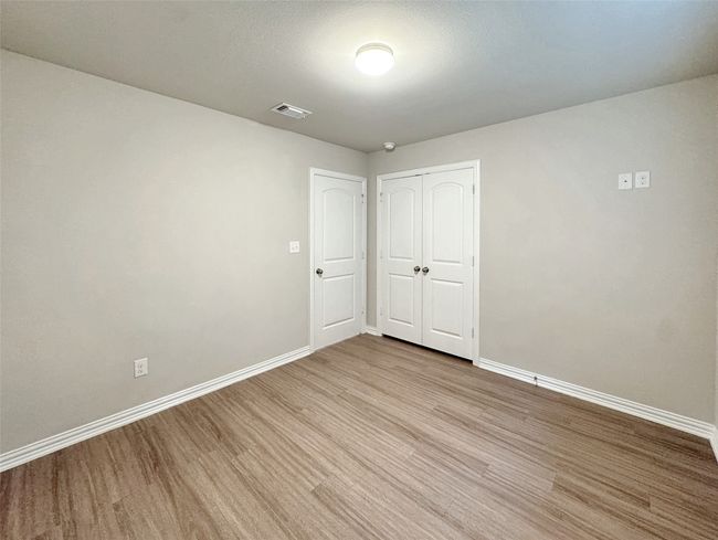 Unfurnished bedroom featuring wood finished floors and a closet | Image 11