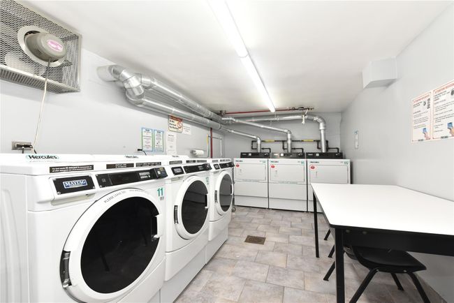 Washroom with washing machine and clothes dryer | Image 21