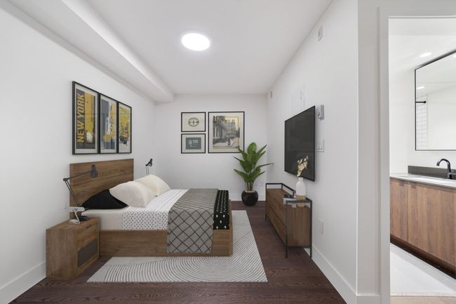 Bedroom featuring a sink and wood finished floors | Image 4