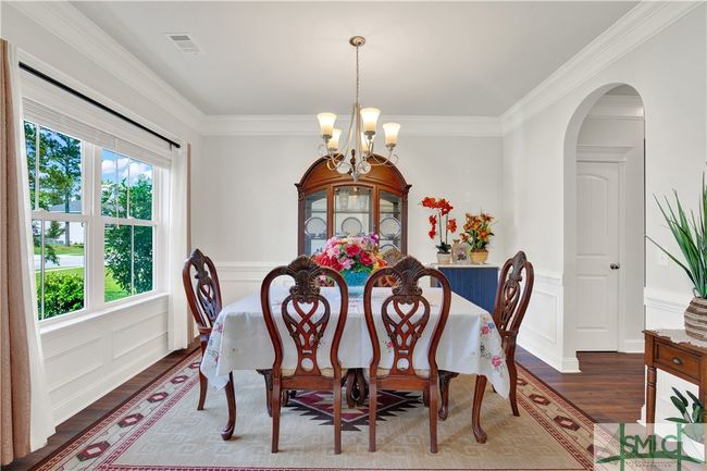 Formal Dining Room with beautiful molding, arched entry to kitchen, LVP wood look flooring | Image 6