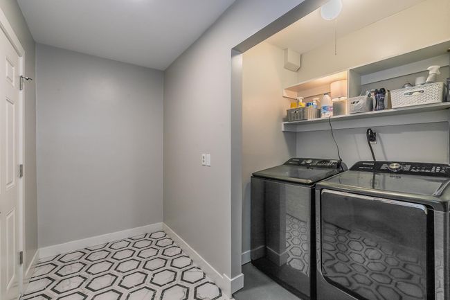 Laundry area with washing machine and clothes dryer and baseboards | Image 21
