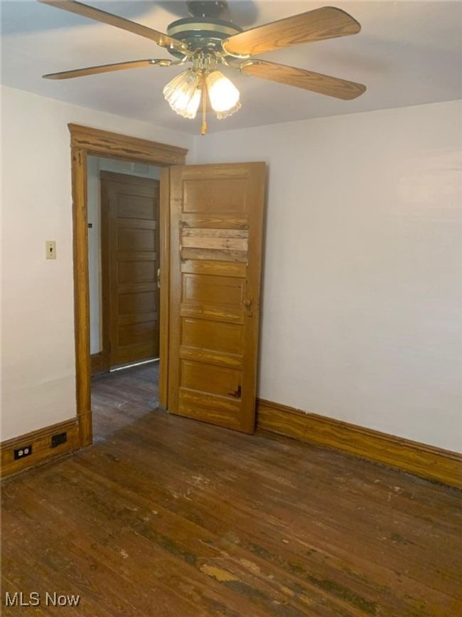 Spare room featuring ceiling fan and dark wood finished floors | Image 10