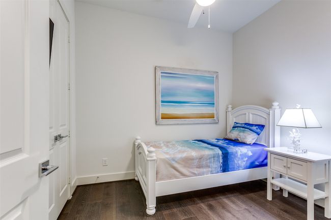 Bedroom featuring baseboards and dark wood-style flooring. | Image 18