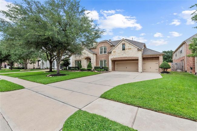 Long driveway offers plenty of space for kids to play hopscotch or for parking during gatherings. | Image 48