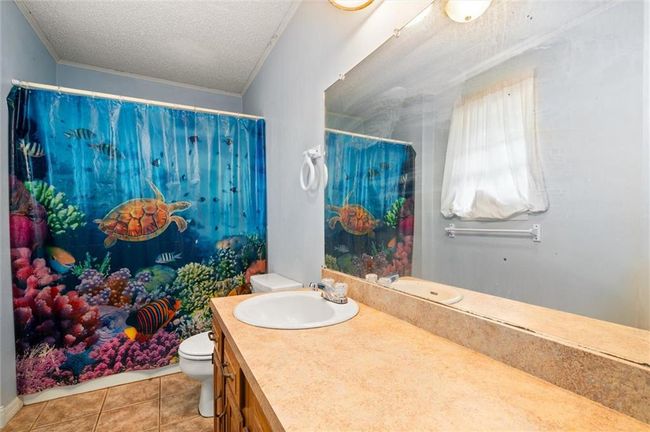 Full bath with ceramic tile. | Image 12