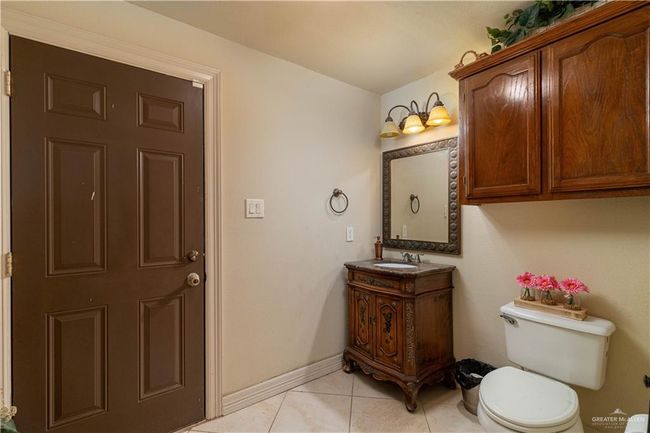 Bathroom featuring toilet, vanity, and tile patterned flooring | Image 16