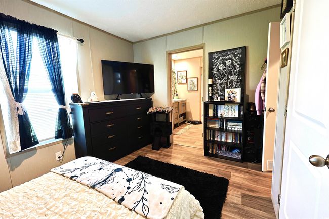 Bedroom featuring wood finished floors and ornamental molding | Image 17