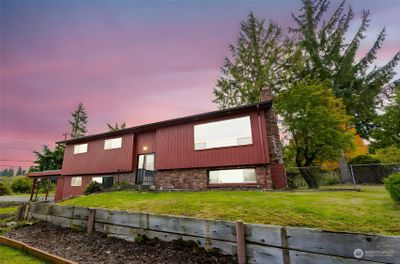 Front Elevation of the home. This side faces the water and look to the north. Behind the home is the deck and views of the mountains. | Image 1