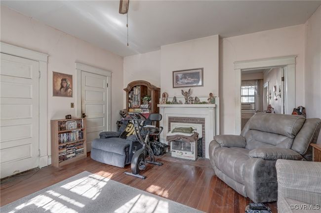 Living room featuring a fireplace and wood finished floors | Image 18