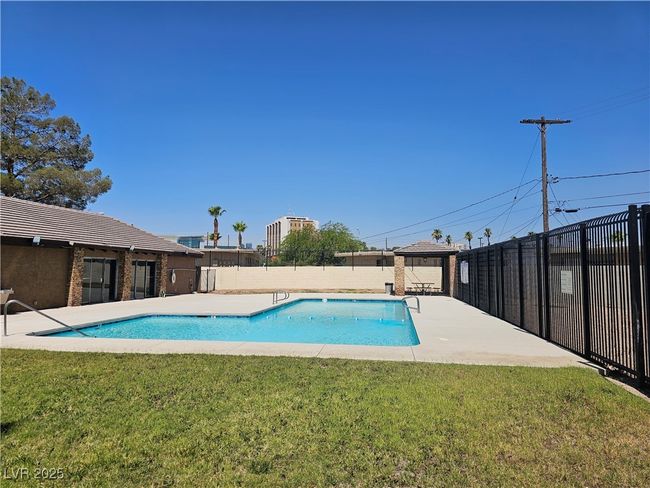 Community pool with a fenced backyard and a gazebo | Image 11