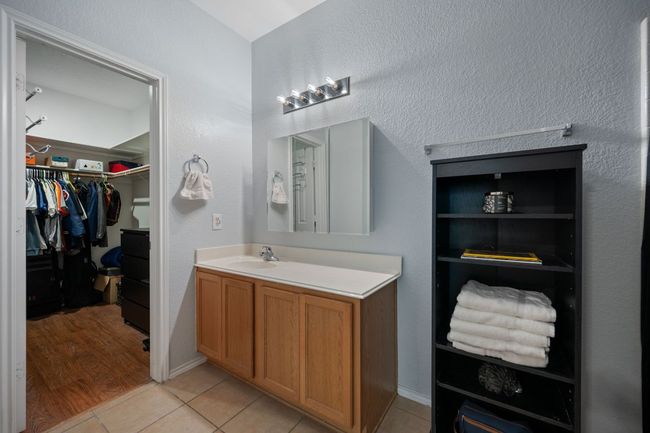 Bathroom with vanity, tile patterned flooring, and a spacious closet | Image 18