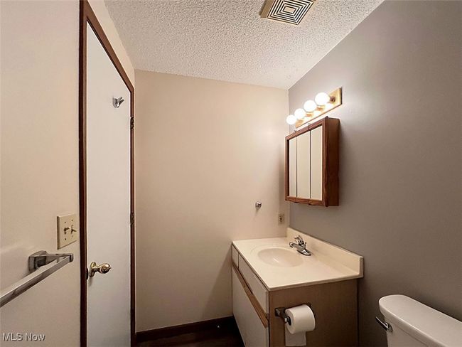 Master bathroom with vanity and a textured ceiling | Image 11