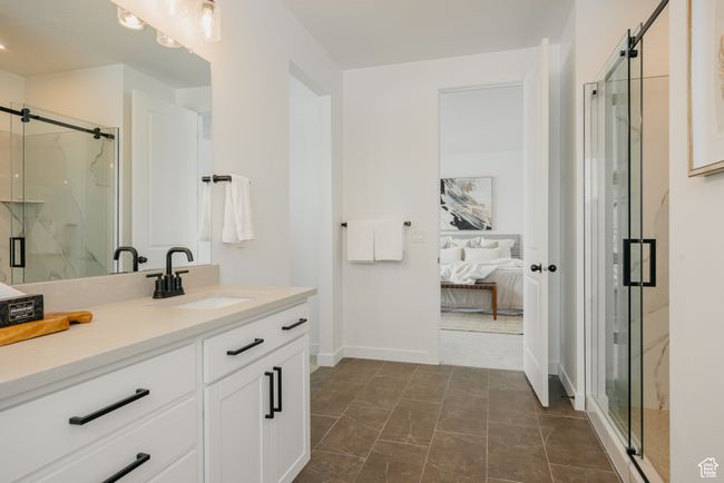 Ensuite bathroom with vanity, a marble finish shower, and baseboards | Image 30
