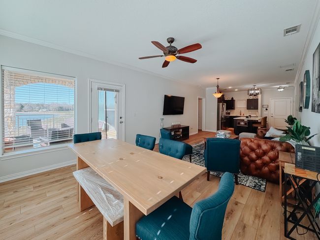 View showing dining area, living area and patio. | Image 9