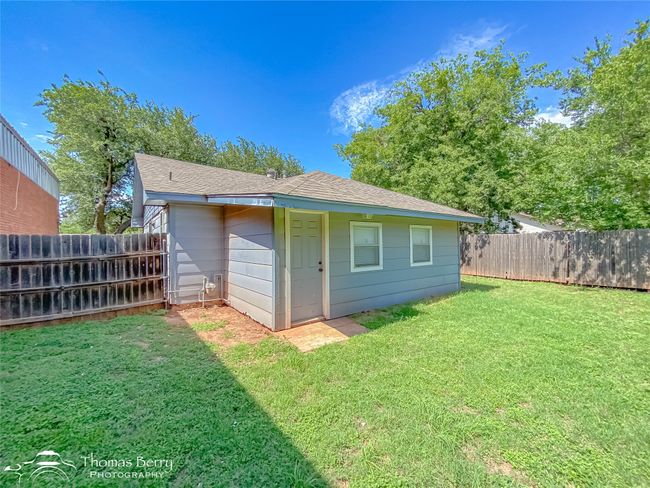 Back of house with a fenced backyard and roof with shingles | Image 30