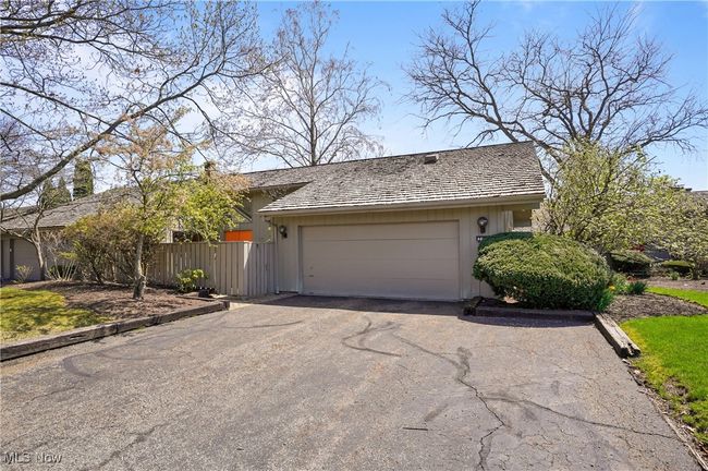 View of front of home with driveway, fence, and a garage | Image 44