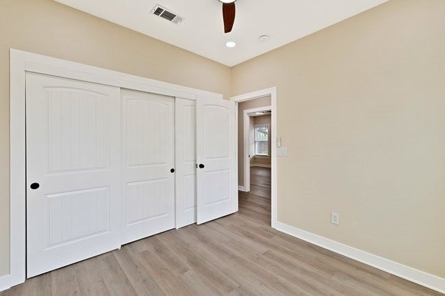 Unfurnished bedroom with baseboards, a closet, and light wood finished floors | Image 18