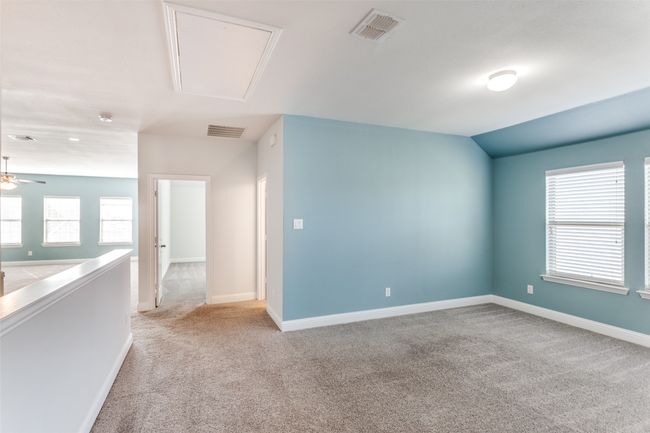 Spare room featuring light carpet, vaulted ceiling, and ceiling fan | Image 18
