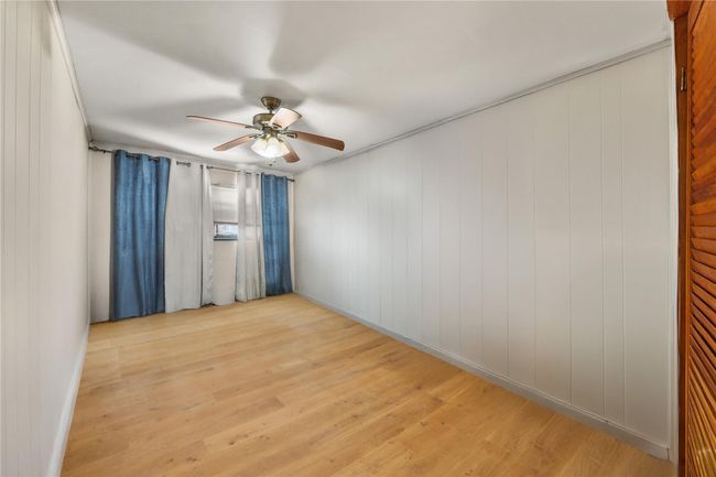 Spare room featuring ceiling fan and wood finished floors | Image 29