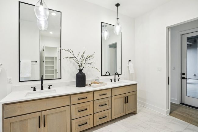 Dual vanities and timeless tile design bring elegance to everyday routines. | Image 23