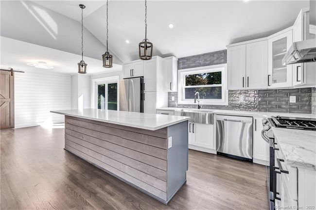 Open concept Kitchen features pristine quartz countertops. | Image 11