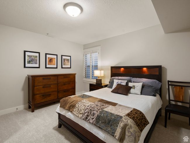 Guest bedroom with light carpet and baseboards | Image 26