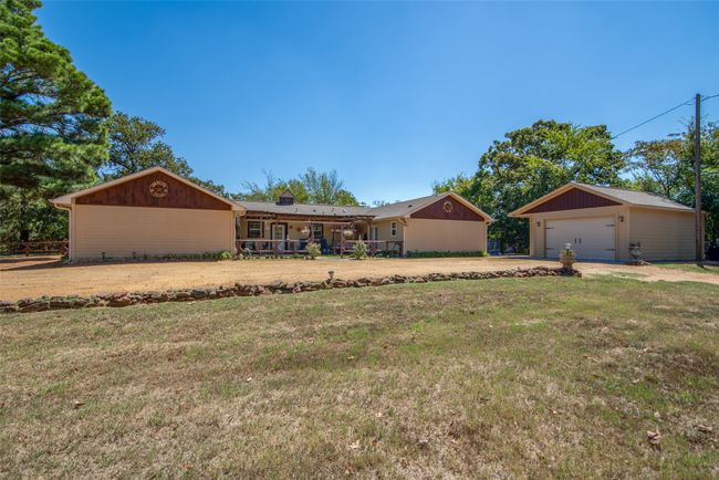 The back of the structure shows the open patio area where people often gather. The attached garage is on the right side here. | Image 4