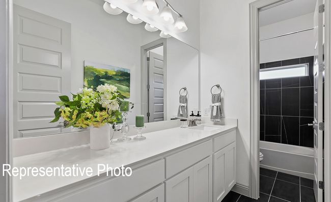 Bathroom featuring vanity, tile patterned floors, and bathtub / shower combination | Image 12