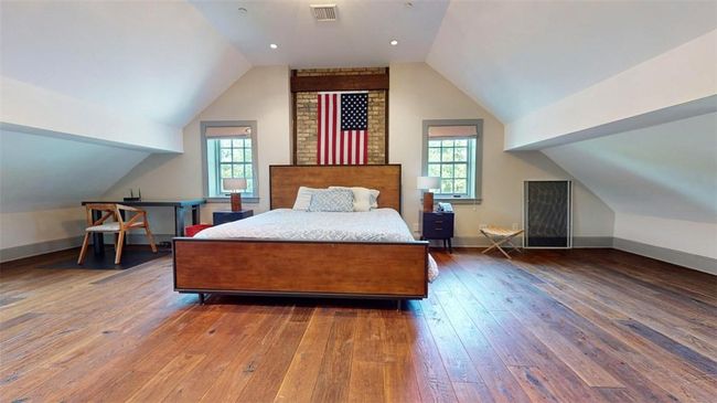 Bedroom featuring hardwood / wood-style flooring, brick wall, and vaulted ceiling | Image 30