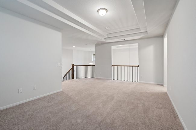 Spare room with baseboards, light carpet, and a raised ceiling | Image 23