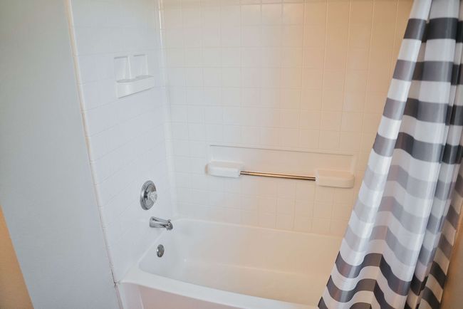 Bathroom featuring shower / tub combo with curtain | Image 30