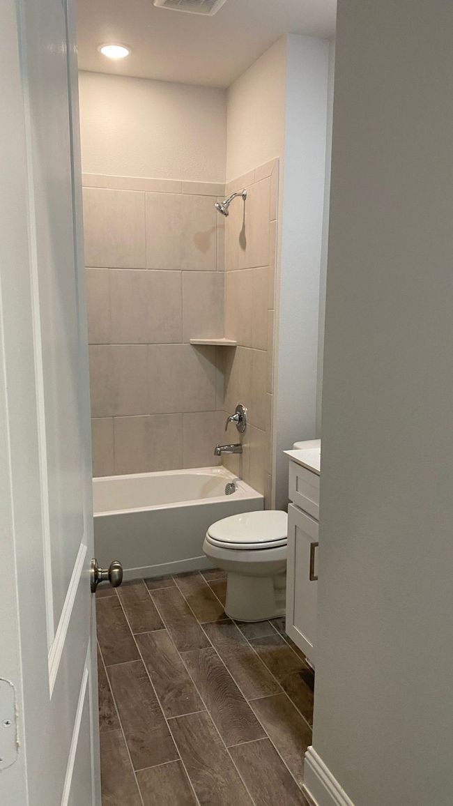 Bathroom featuring toilet, vanity, washtub / shower combination, and recessed lighting | Image 8