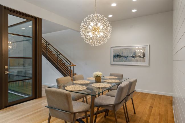 Dining room featuring stairway, light wood-type flooring, recessed lighting, a chandelier, and baseboards | Image 12