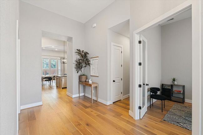 Hallway featuring light wood-style floors, baseboards, and french doors | Image 5