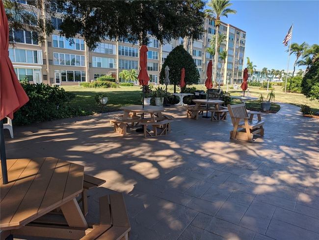 Sitting area with grill and picnic tables | Image 23